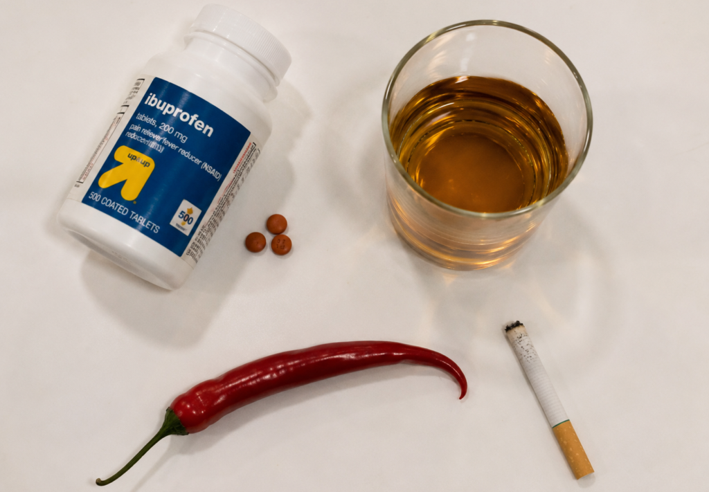 Common causes of gastritis symptoms including NSAIDs alcohol spicy food and smoking