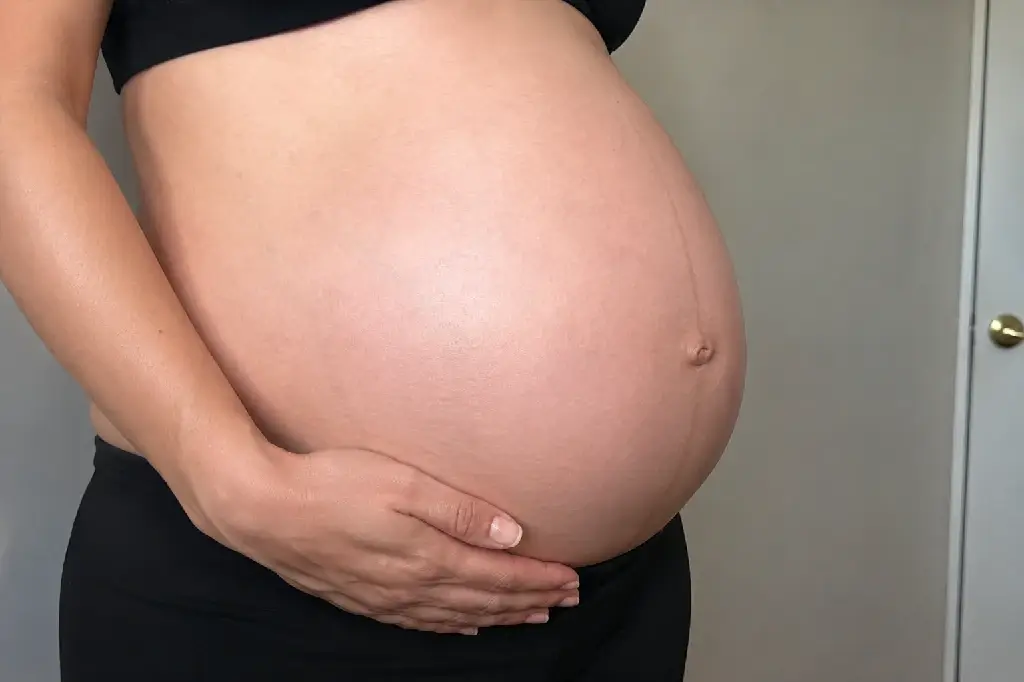close up of a pregnant belly showing where cramps during pregnancy are often felt