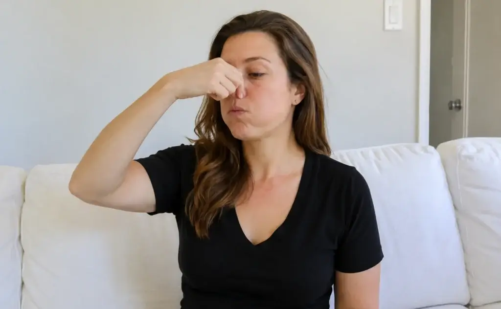 person performing valsalva maneuver to drain middle ear fluid